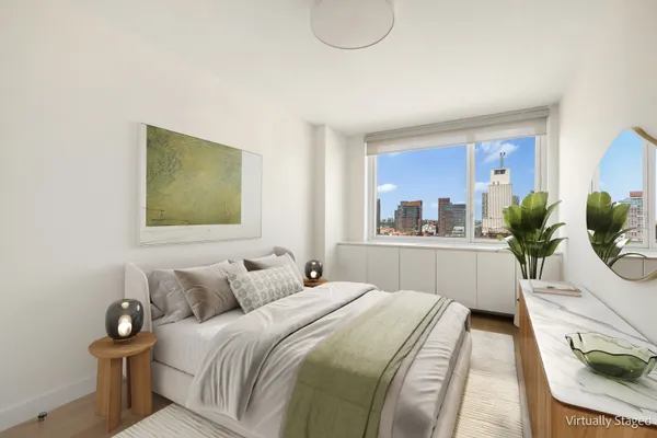 a bedroom with a bed and a potted plant
