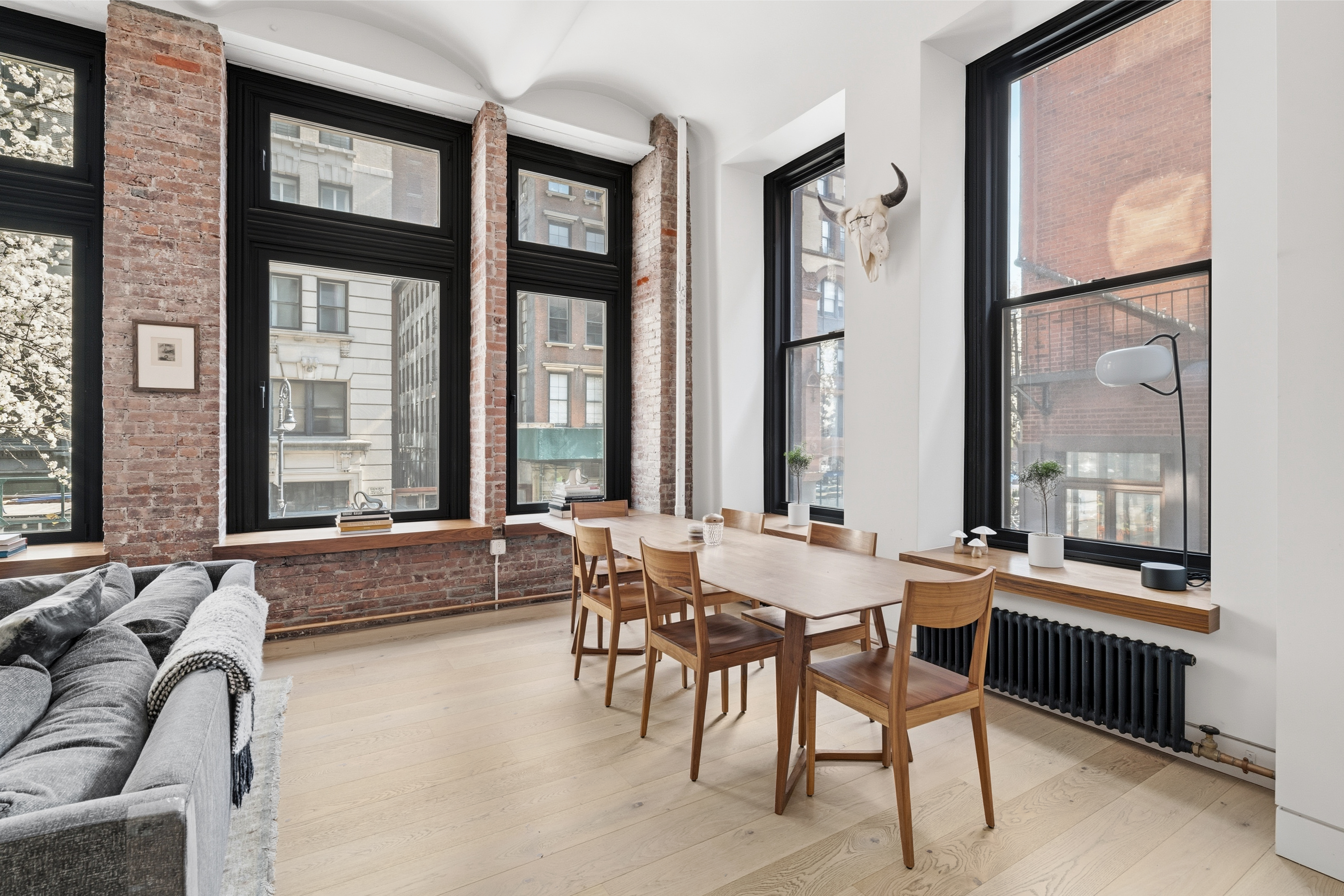 1 Great Jones St, Unit 2B Manhattan, NY 10012 - Photo 5 of 12 a dining room with furniture and large windows