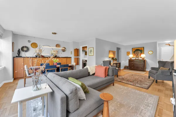 a living room with furniture and wooden floor