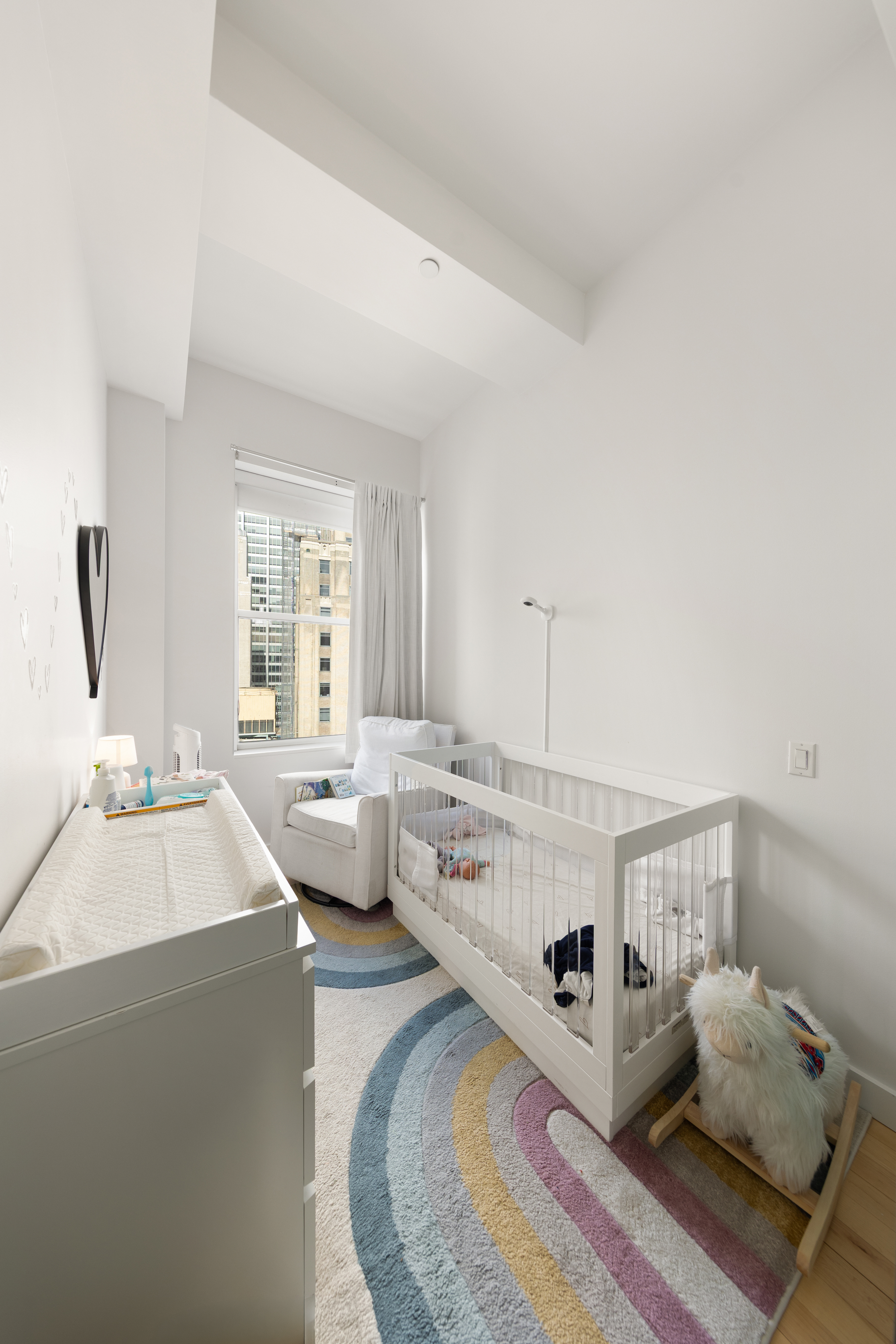 15 Broad Street, Unit 3100 Manhattan, NY 10005 - Photo 8 of 27 a living room with furniture and a large window