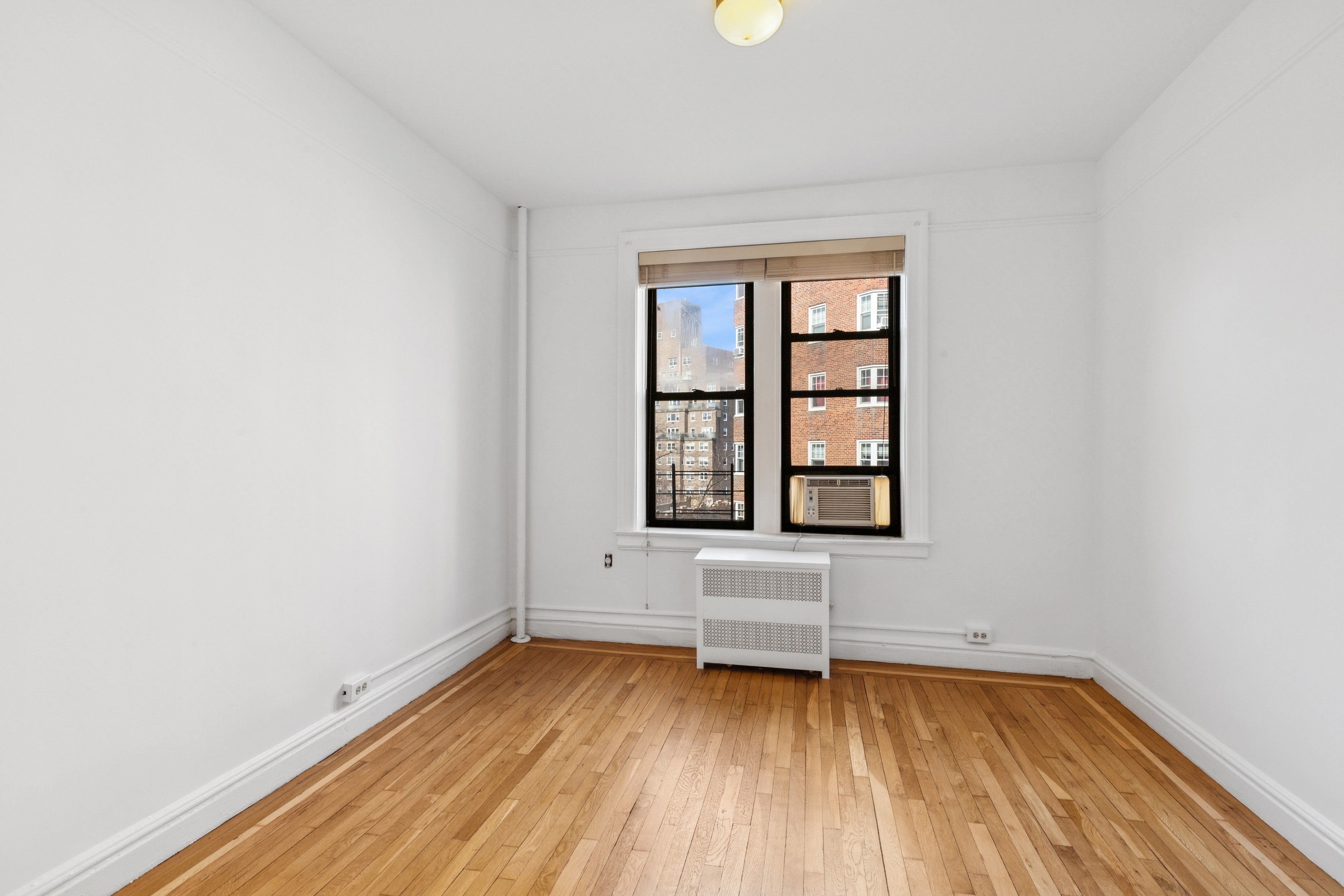 115 Cabrini Boulevard, Unit B51 Manhattan, NY 10033 - Photo 14 of 23 an empty room with a window