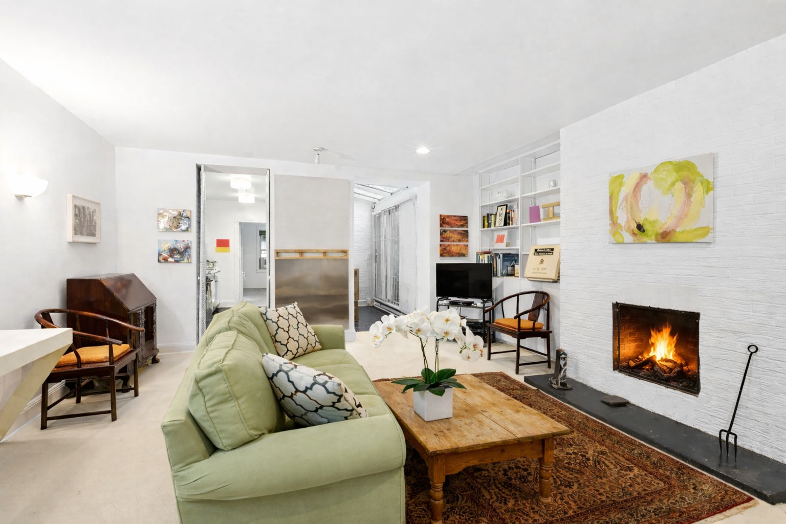 50 East 83rd Street, Unit 1R Manhattan, NY 10028 - Photo 2 of 12 a living room with furniture and a fireplace
