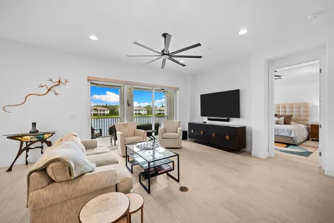 a living room with furniture and a ceiling fan
