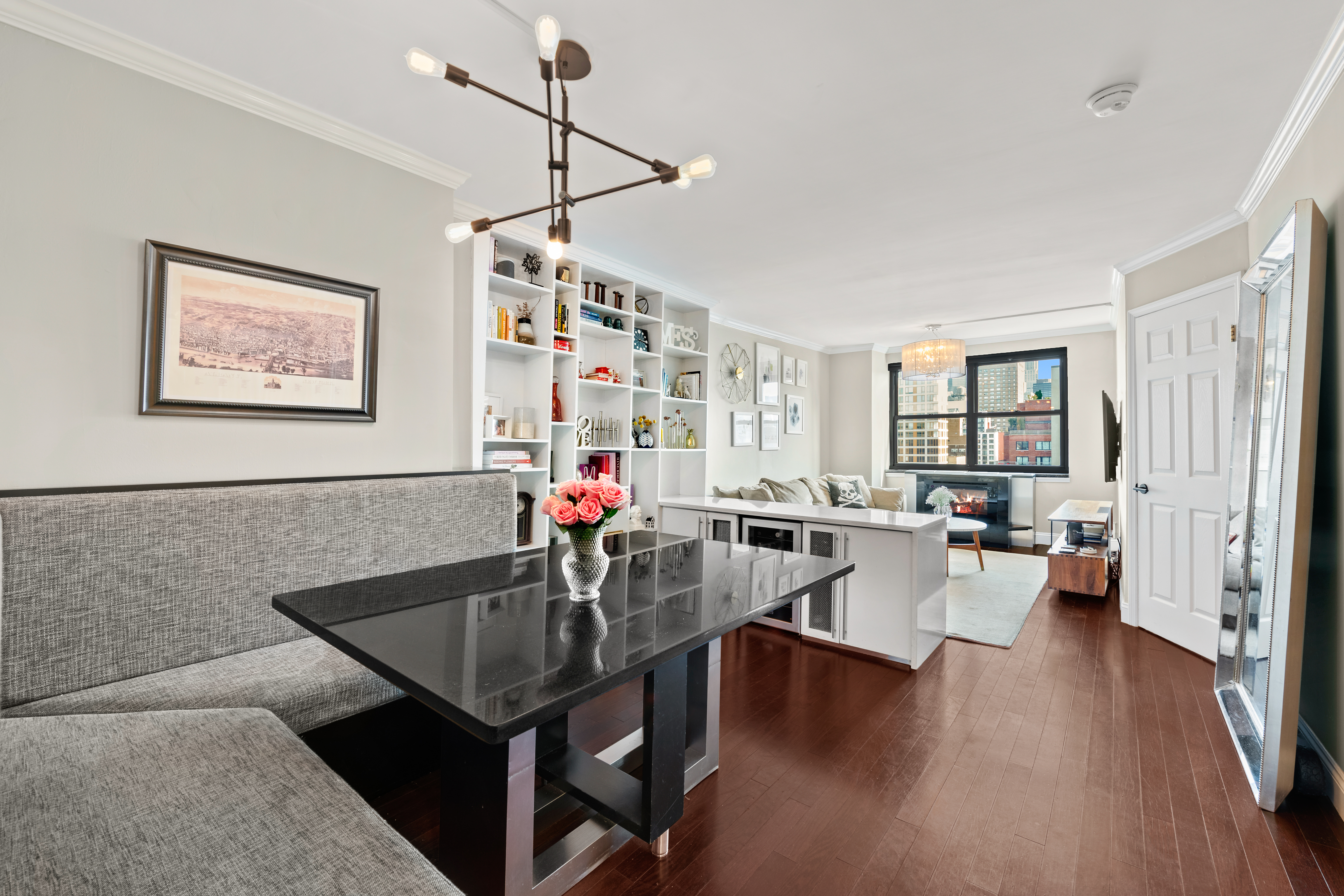 200 East 24th Street, Unit 1807 Manhattan, NY 10010 - Photo 3 of 10 a view of a dining room with furniture window and wooden floor