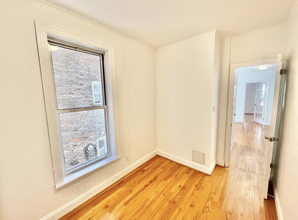 80 East 7th Street, Unit 4C Manhattan, NY 10003 - Photo 4 of 7 a view of a room with wooden floor and a bathroom