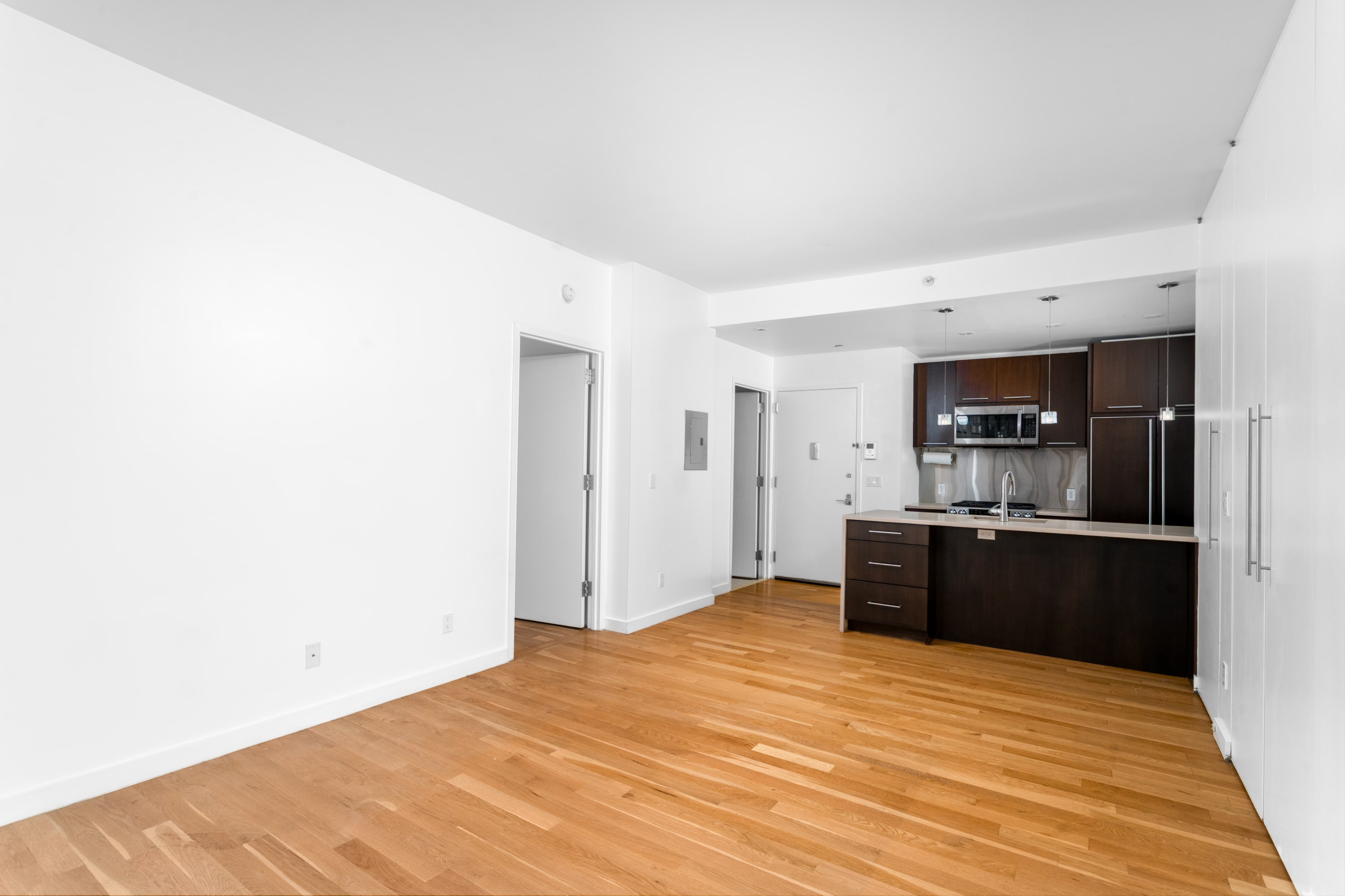 342 East 110th Street, Unit 3D Manhattan, NY 10029 - Photo 5 of 15 a large kitchen with a wooden floor and a sink