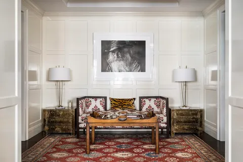 a living room with furniture and a lamp