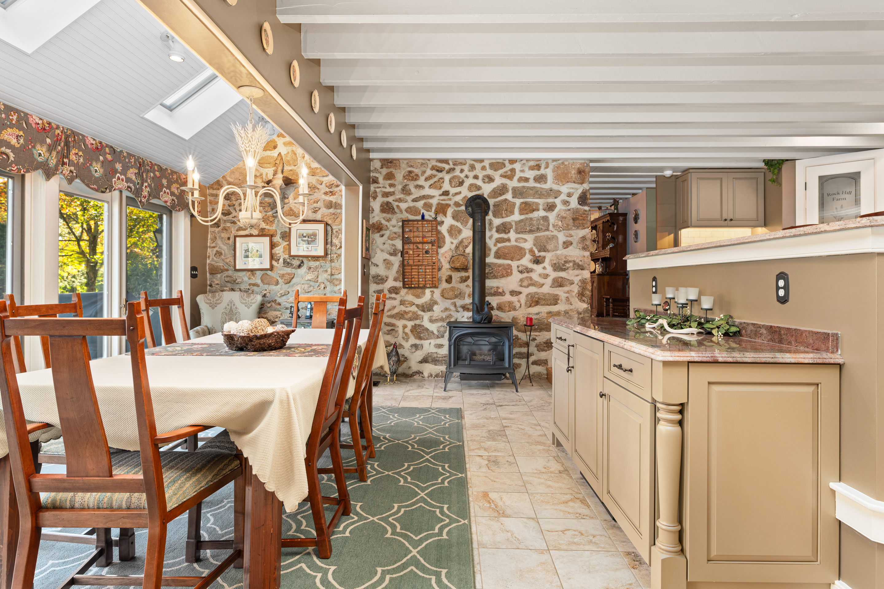 791 Grubbs Mill Road Berwyn, PA 19312 - Photo 18 of 76 a kitchen with stainless steel appliances kitchen island granite countertop a table chairs and a wooden floor