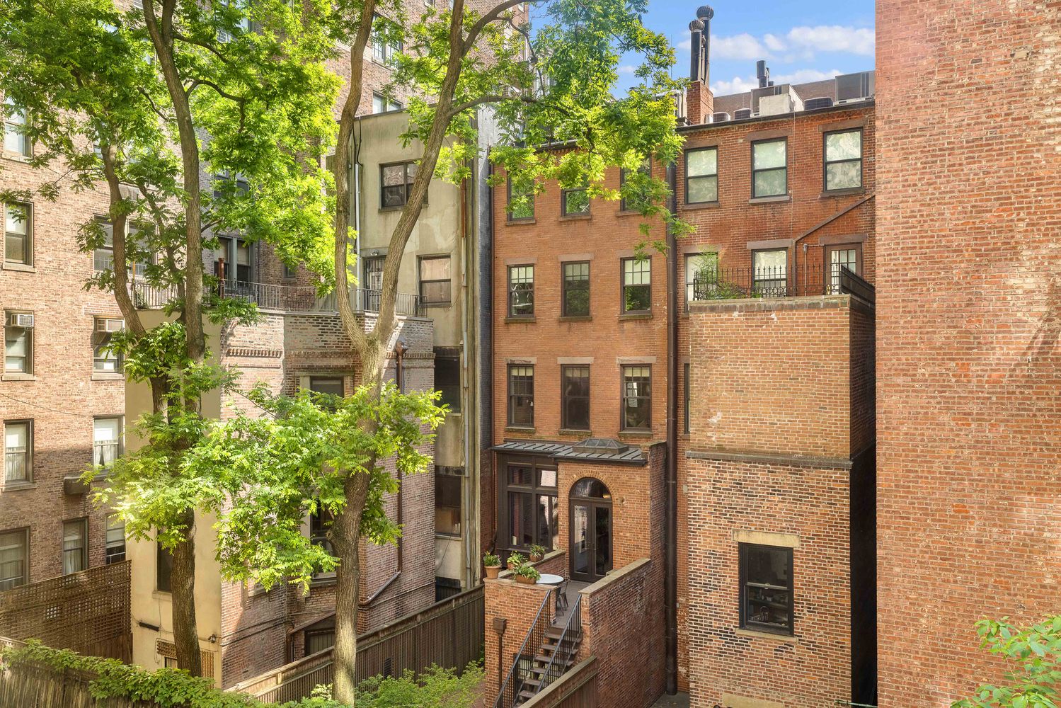 60 East 79th Street, Unit 3B Manhattan, NY 10075 - Photo 5 of 8 a front view of a building with a garden