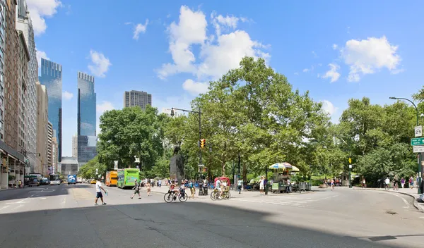 a view of a street with cars on both side of the road