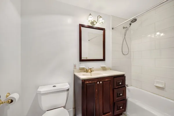 a bathroom with a sink toilet vanity and shower