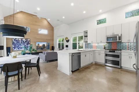 a kitchen with a sink stove and white cabinets