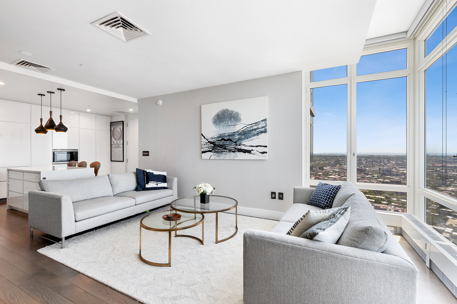 a living room with furniture floor to ceiling window and a table
