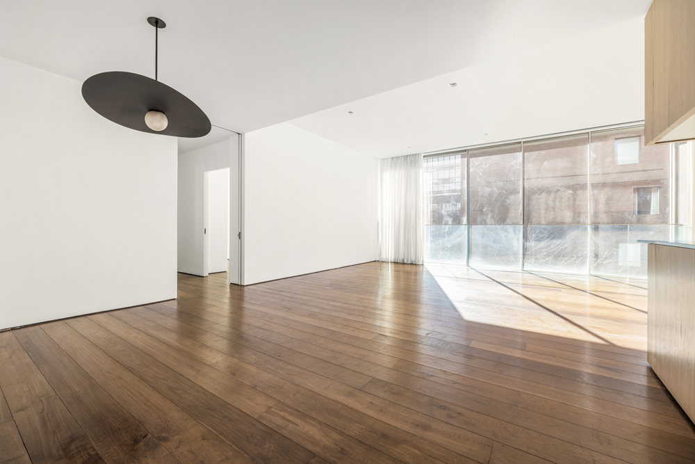 527 West 27th Street, Unit 3C Manhattan, NY 10001 - Photo 5 of 14 a view of an empty room with wooden floor and a window
