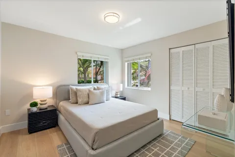 a bedroom with a bed and a flat screen tv
