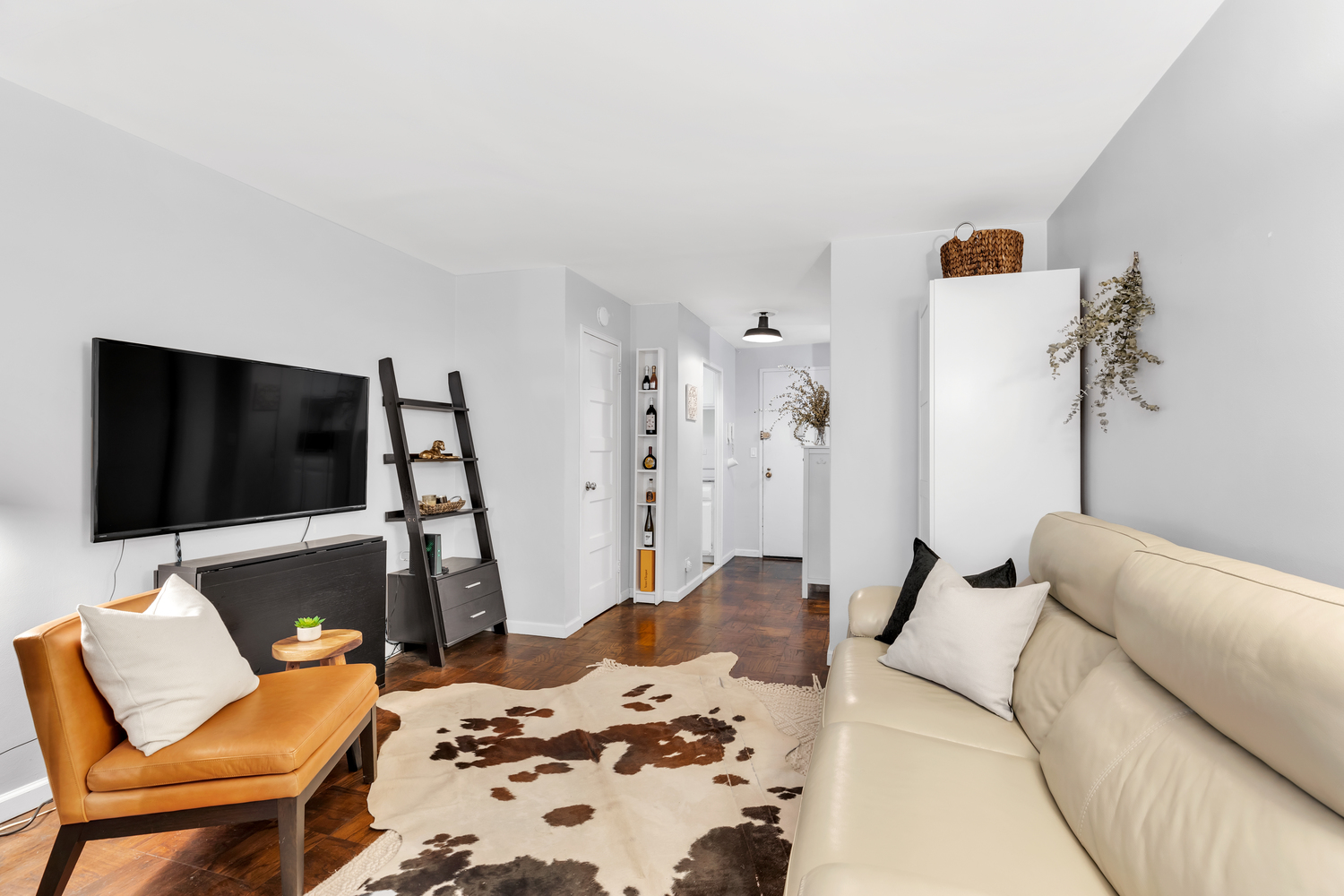 10 West 15th Street, Unit 713 Manhattan, NY 10011 - Photo 2 of 6 a bedroom with a bed and a flat screen tv