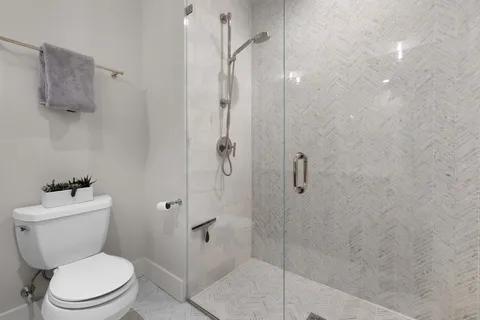 a white toilet sitting next to a bathroom sink