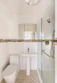 a bathroom with a sink toilet and shower