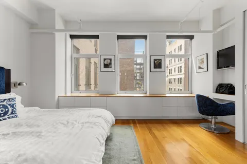 a bedroom with a bed and a chair