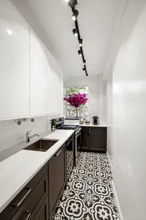 a kitchen with a sink and cabinets
