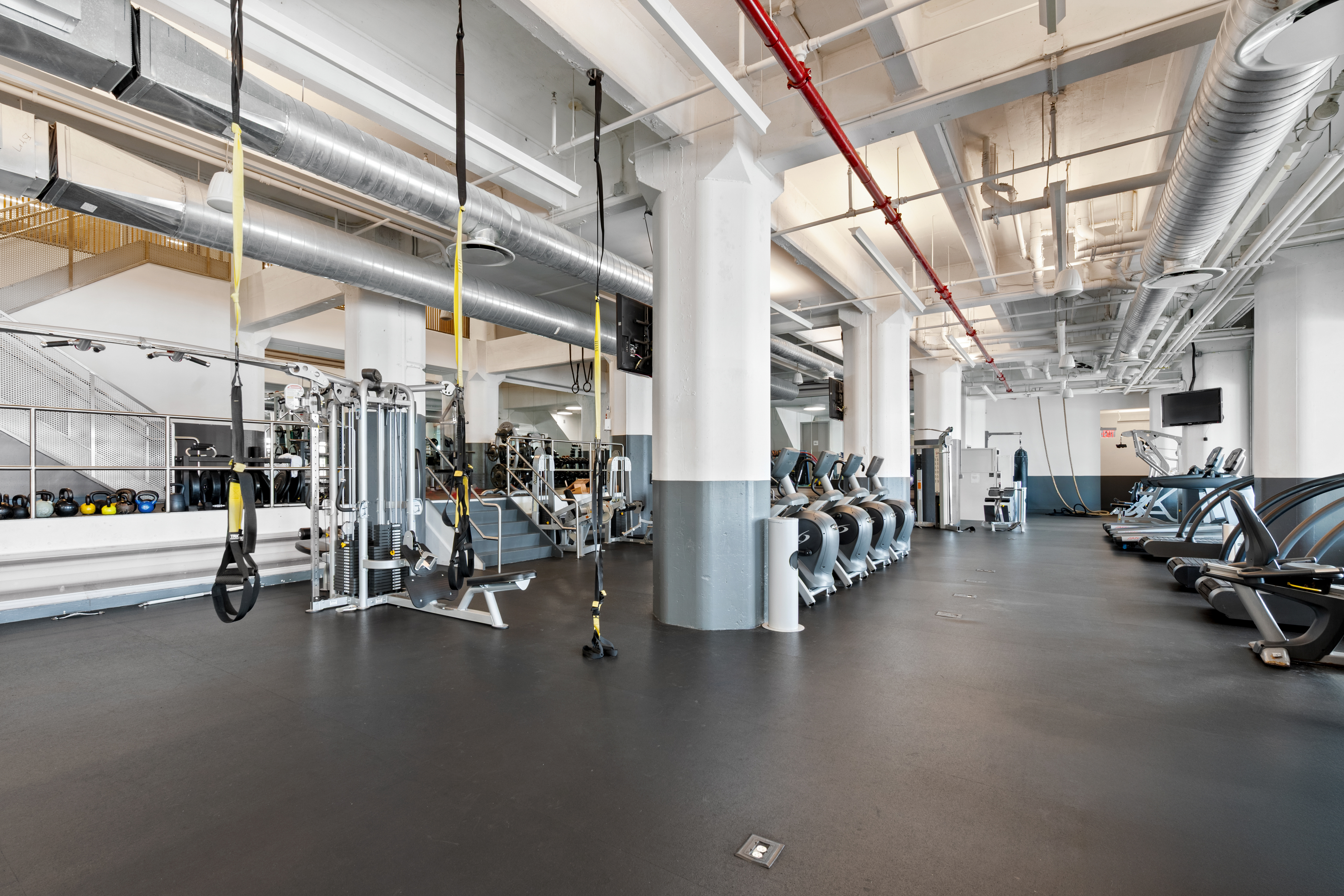 184 Kent Avenue, Unit C107 Brooklyn, NY 11249 - Photo 12 of 18 a view of a room with gym equipment