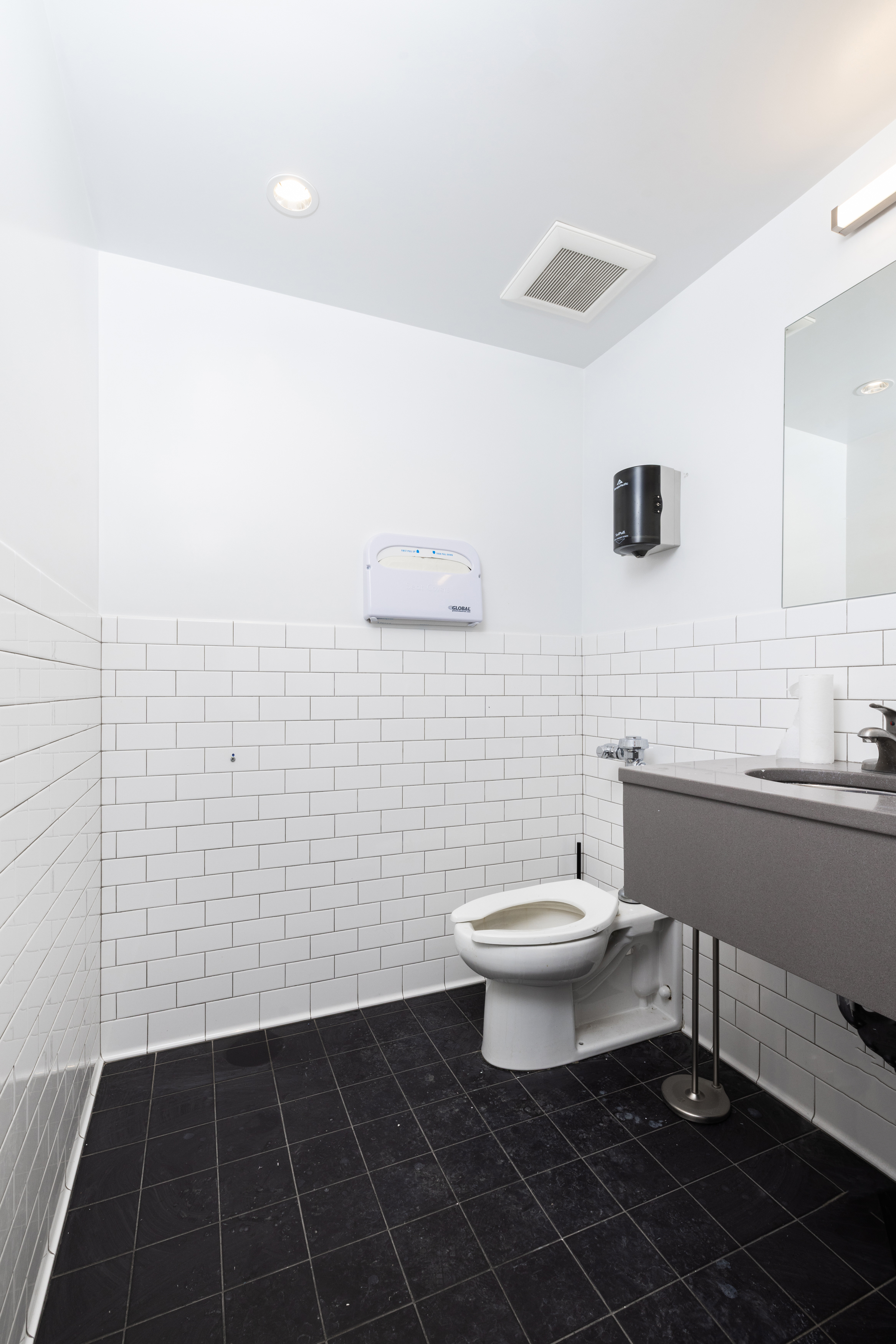 11 West 30th Street, Unit 2F Manhattan, NY 10001 - Photo 9 of 12 a bathroom with a toilet a sink and mirror