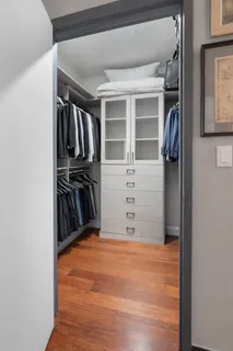 a view of walk in closet with clothes and shoes