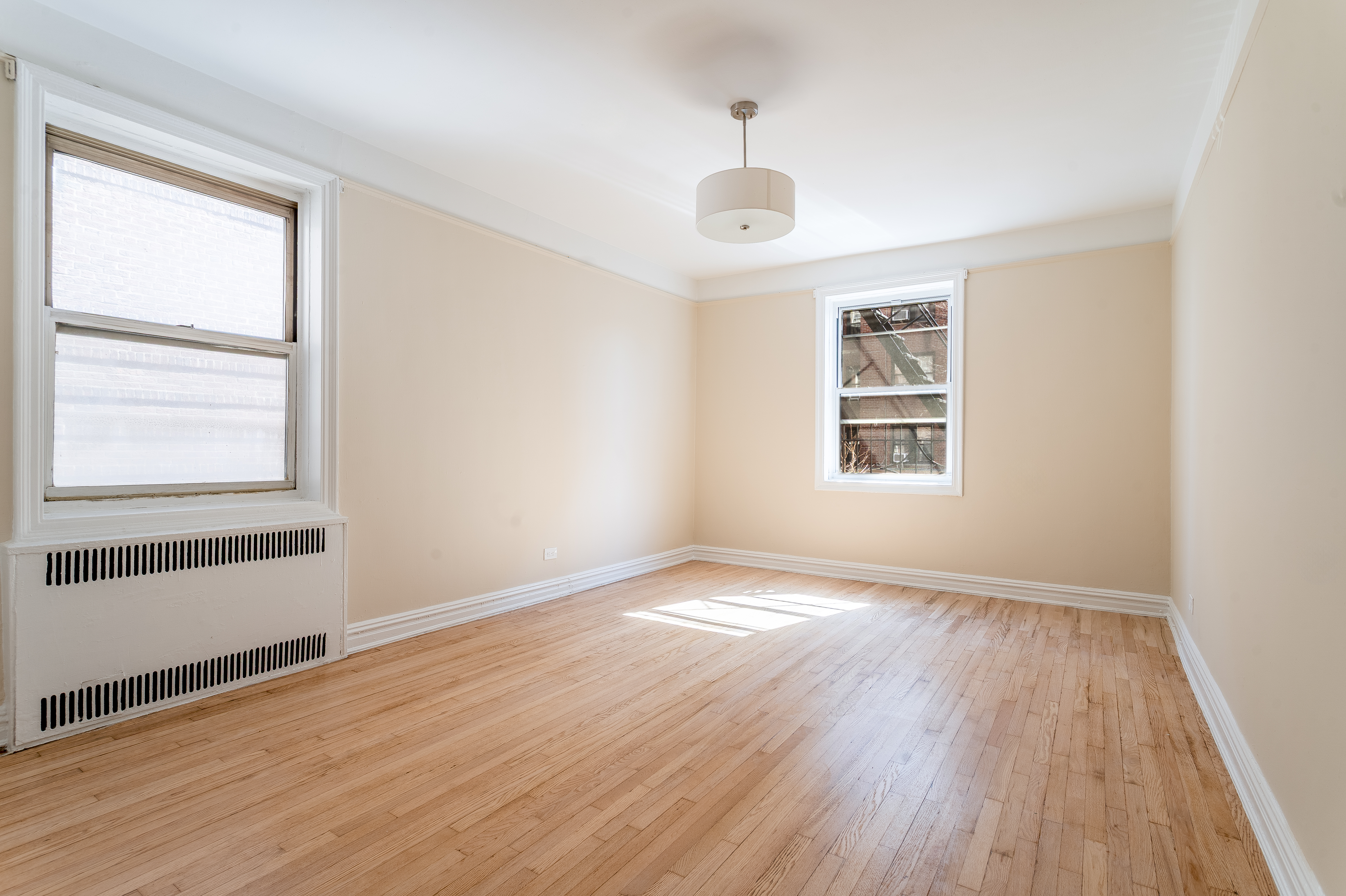 40 Tehama Street, Unit 2E Brooklyn, NY 11218 - Photo 5 of 12 an empty room with wooden floor and windows