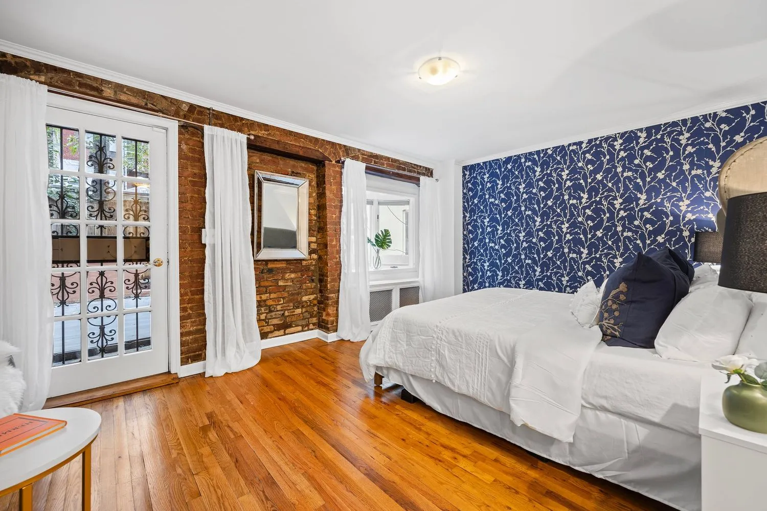 a bedroom with a large bed and a large window