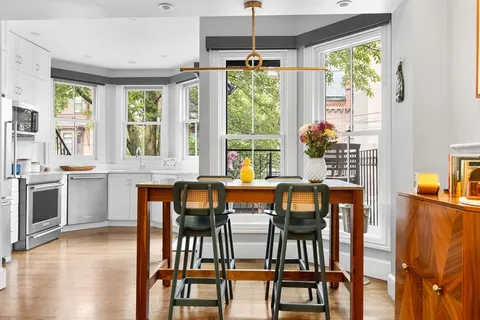 a view of a dining room with furniture window and wooden floor