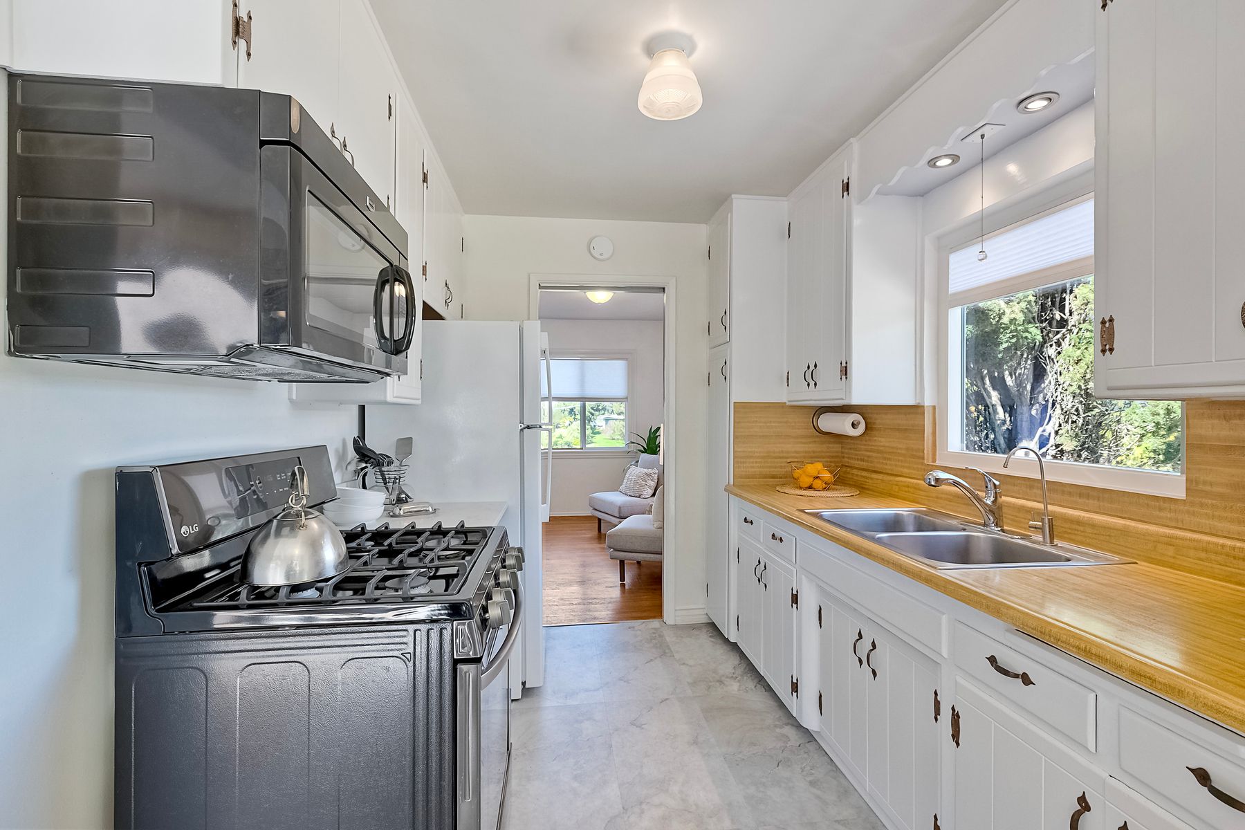 534 Hoover Street Oceanside, CA 92054 - Photo 14 of 31 a kitchen with stainless steel appliances granite countertop a sink stove and cabinets