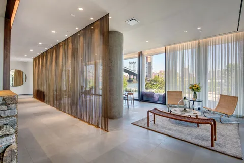 a living room with furniture and large windows