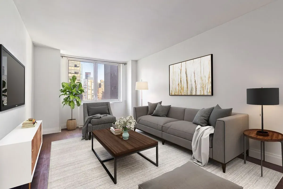 212 East 47th Street, Unit 21D Manhattan, NY 10017 - Photo 5 of 16 a living room with furniture and a flat screen tv