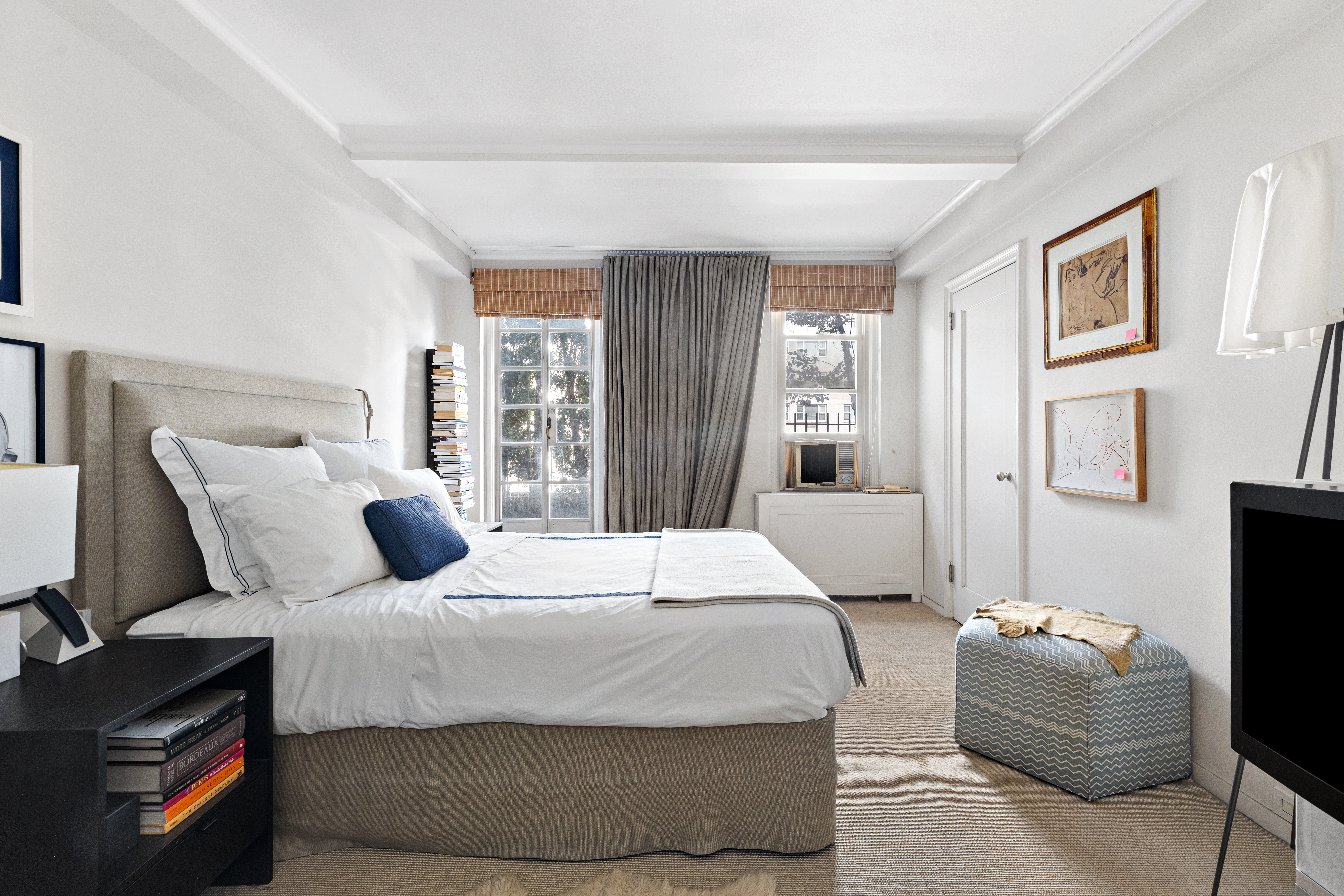 59 West 12th Street, Unit 11C Manhattan, NY 10011 - Photo 5 of 10 a bedroom with a bed and wooden floor