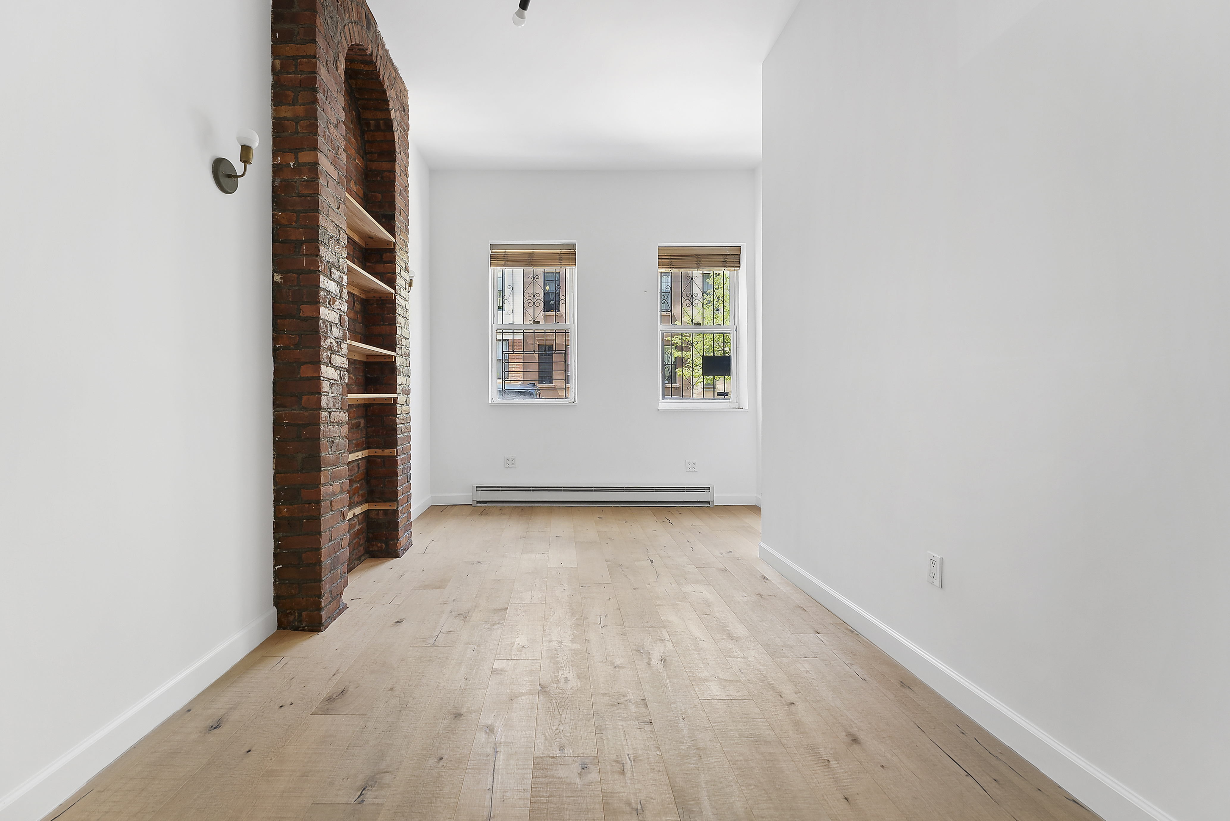 768 Hart Street, Unit 1 Brooklyn, NY 11237 - Photo 6 of 18 an empty room with windows