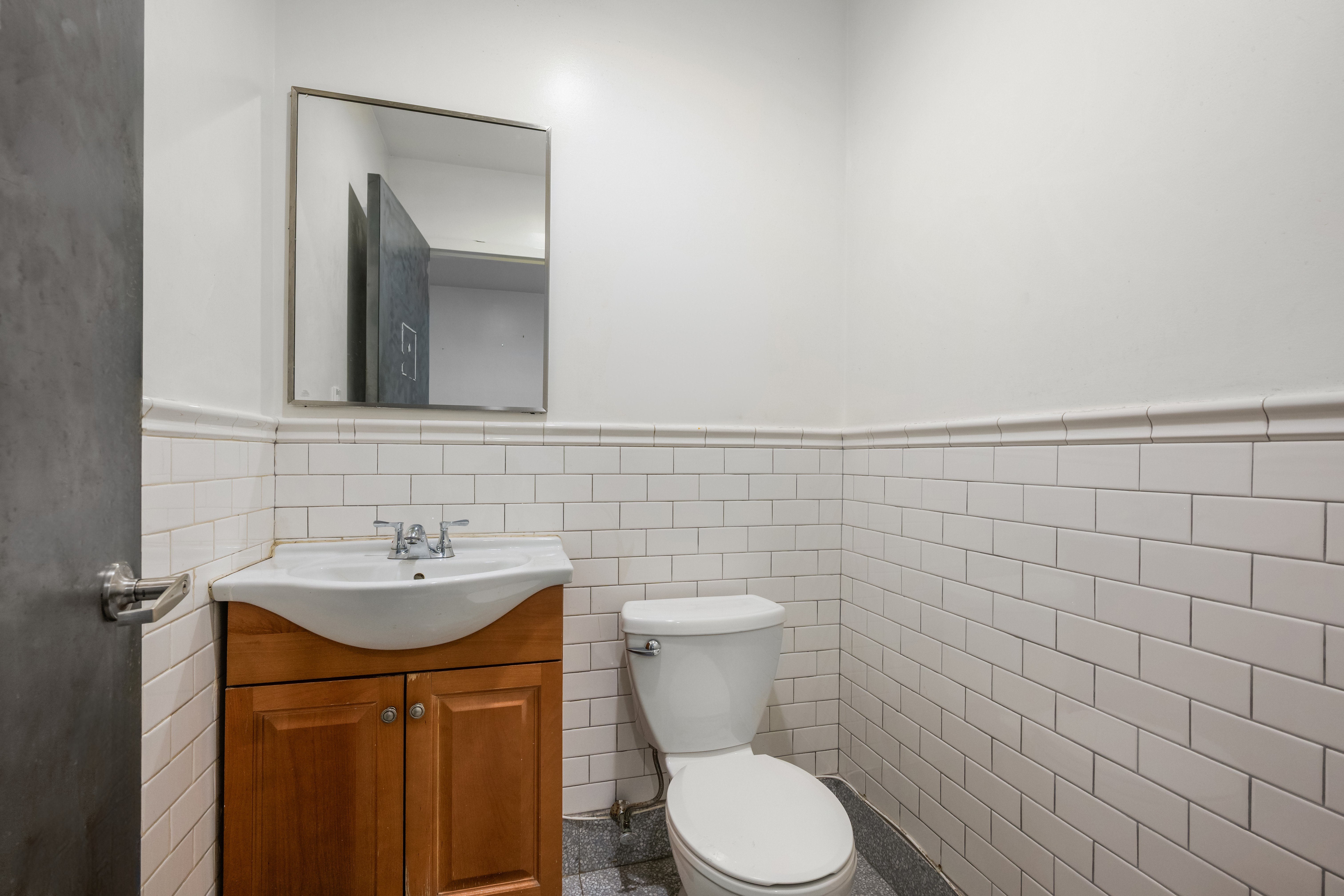 273 Lenox Avenue Manhattan, NY 10027 - Photo 10 of 15 a bathroom with a sink and a toilet
