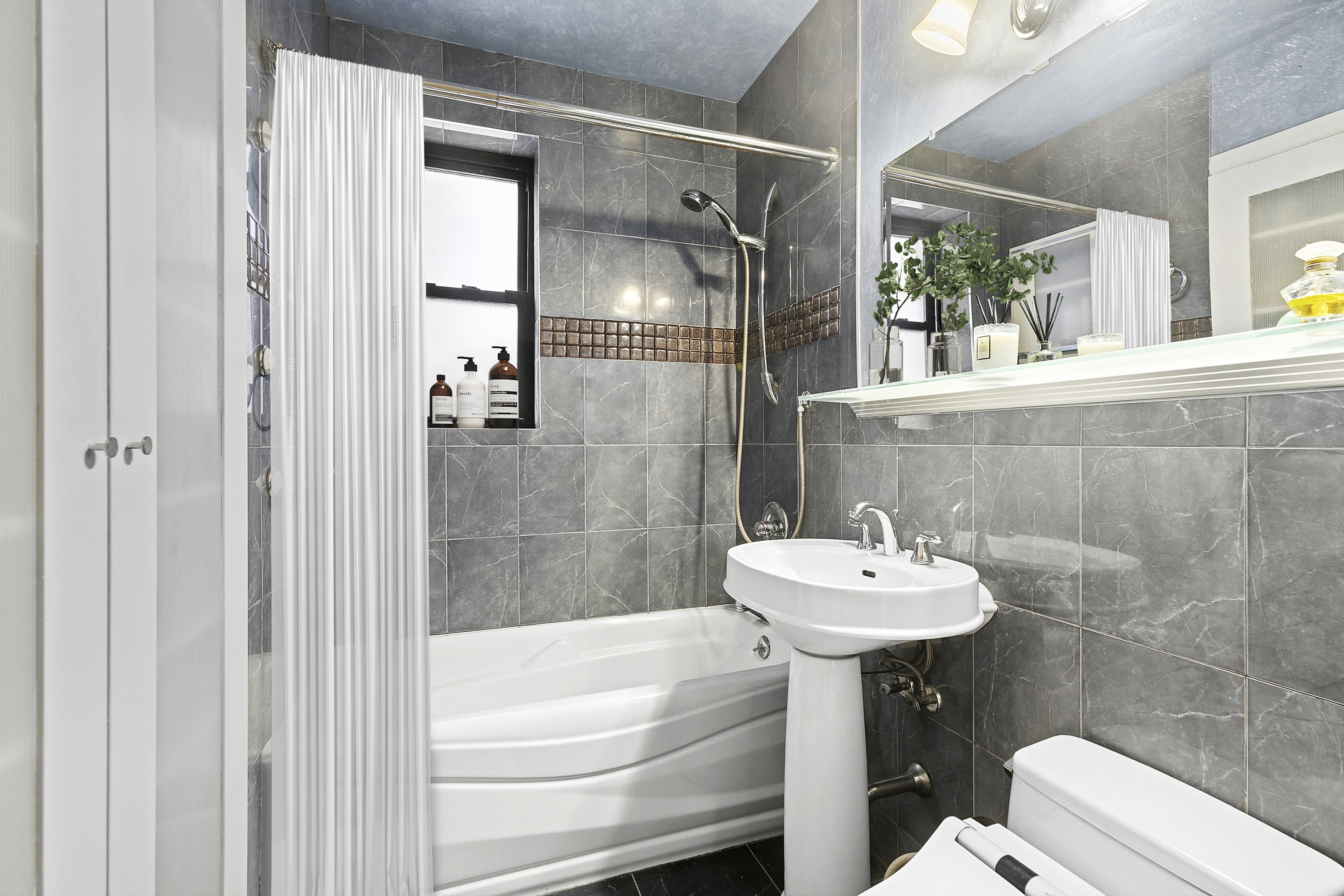 3025 Ocean Avenue, Unit 1O Brooklyn, NY 11235 - Photo 6 of 9 a bathroom with a sink a toilet and shower