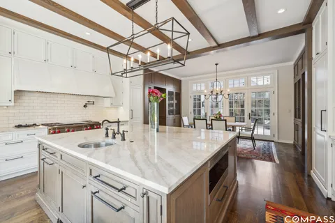 a kitchen with stainless steel appliances granite countertop a sink a oven and a counter space