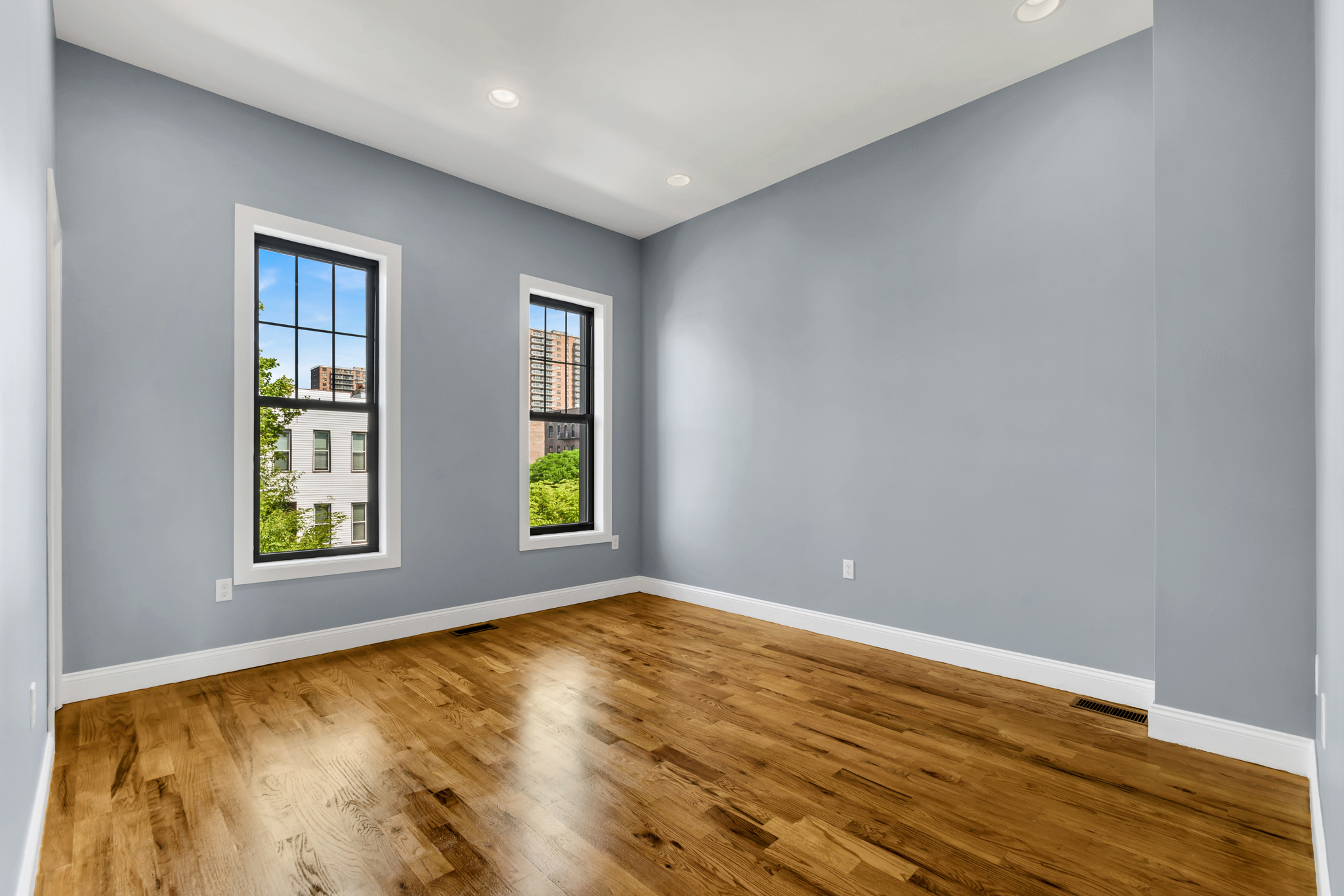 28 Roosevelt Place, Unit 2 Brooklyn, NY 11233 - Photo 10 of 12 a view of an empty room with wooden floor and a window