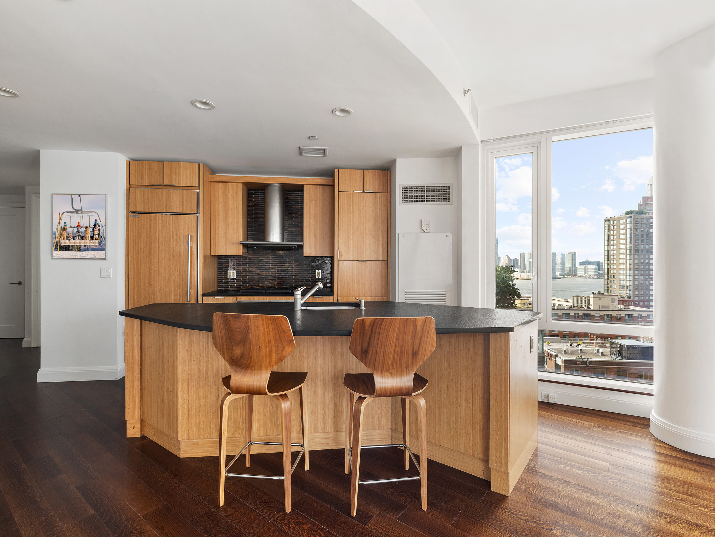 70 Little West Street, Unit 14B Manhattan, NY 10004 - Photo 2 of 17 a view of a dining room with furniture and wooden floor