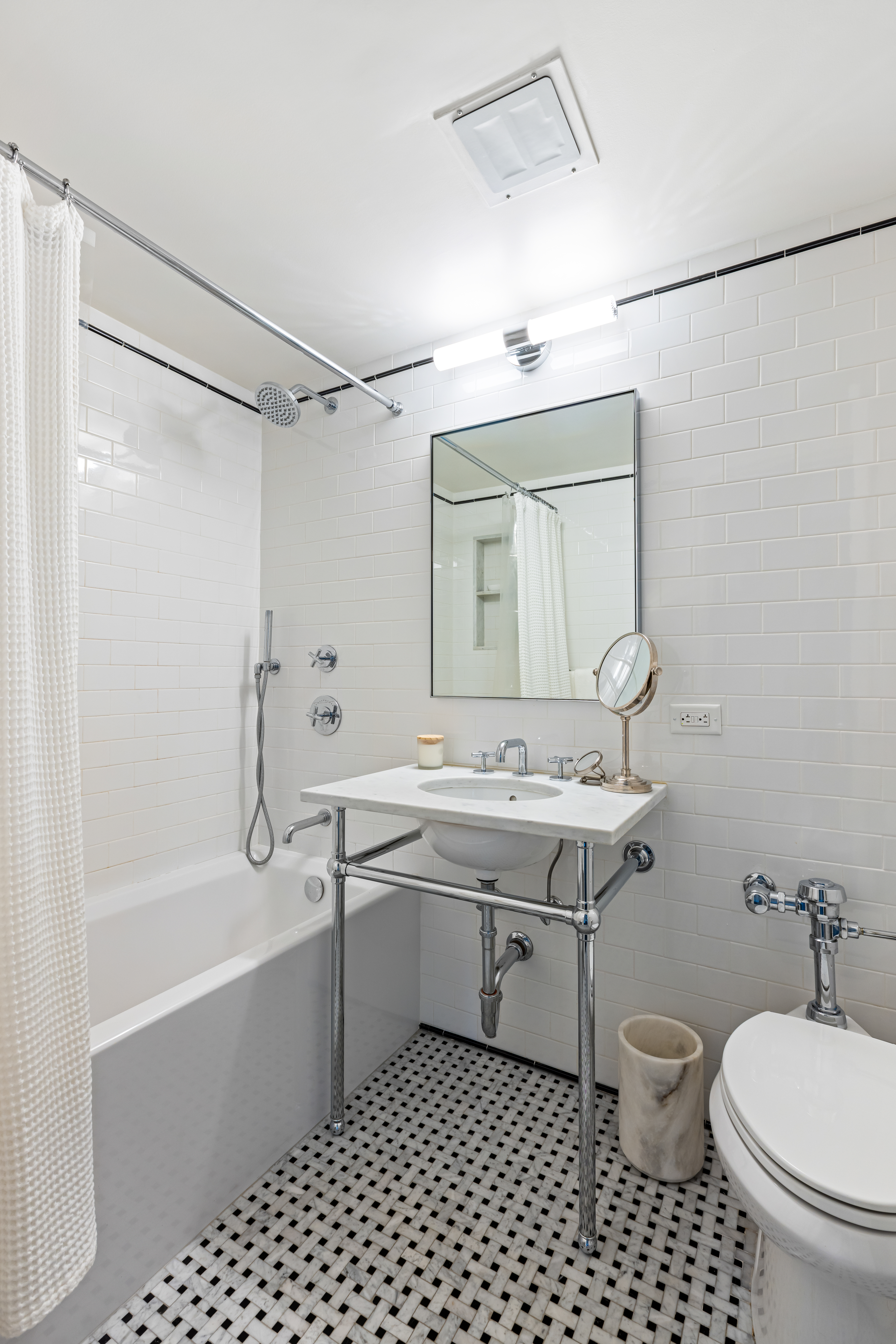 465 West 23rd Street, Unit 15B Manhattan, NY 10011 - Photo 10 of 19 a bathroom with a double vanity sink toilet mirror and shower