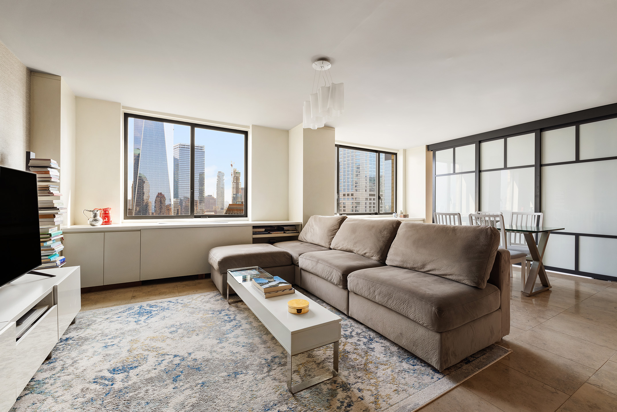 200 Rector Place, Unit 36LM Manhattan, NY 10280 - Photo 3 of 15 a living room with furniture and a flat screen tv