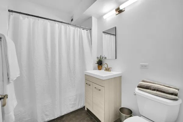 a view of bathroom with a sink and mirror
