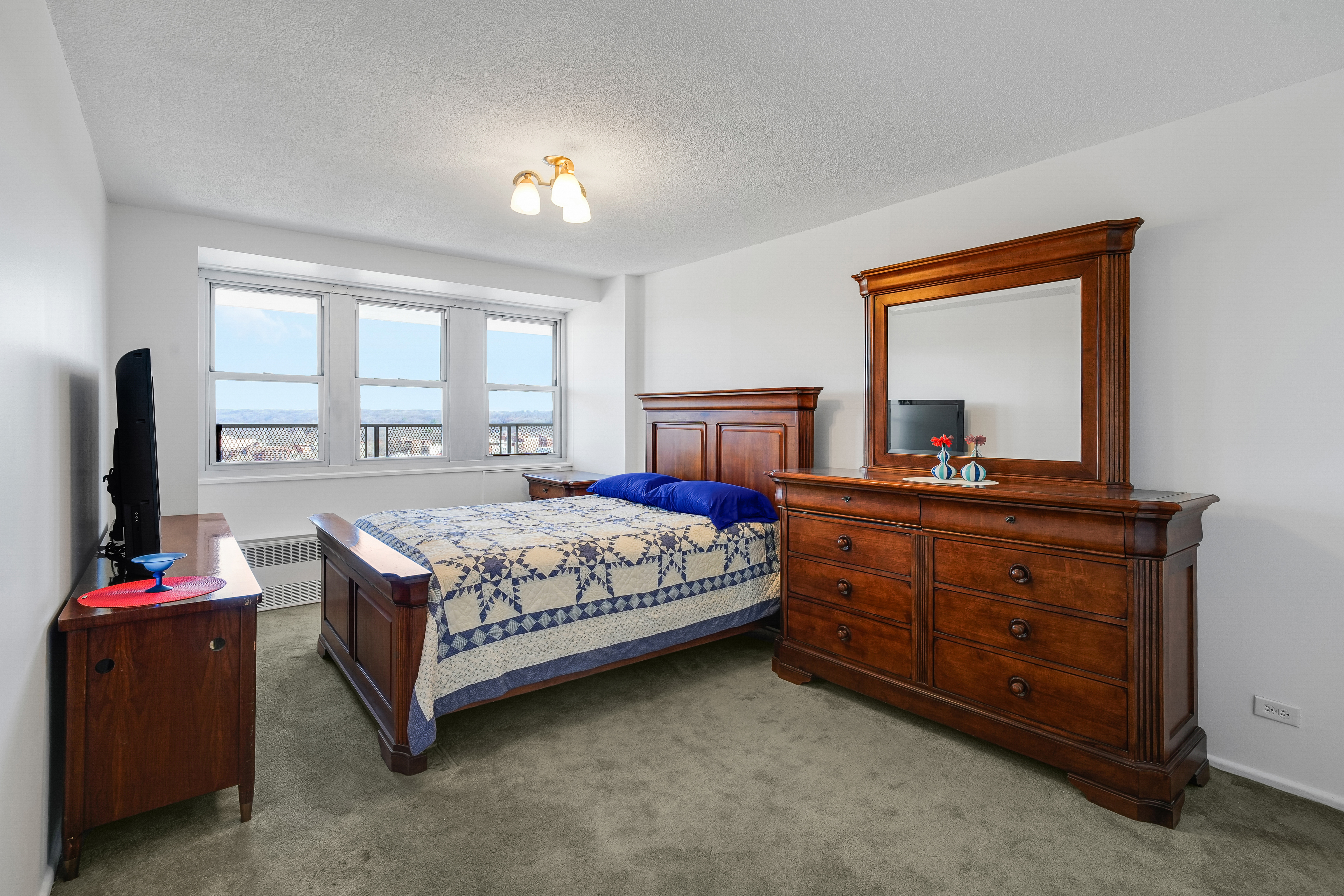 290 West 232nd Street, Unit 18B Bronx, NY 10463 - Photo 8 of 16 a bedroom with a bed and a dresser