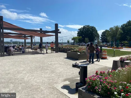 a view of a patio with table and chairs potted plants