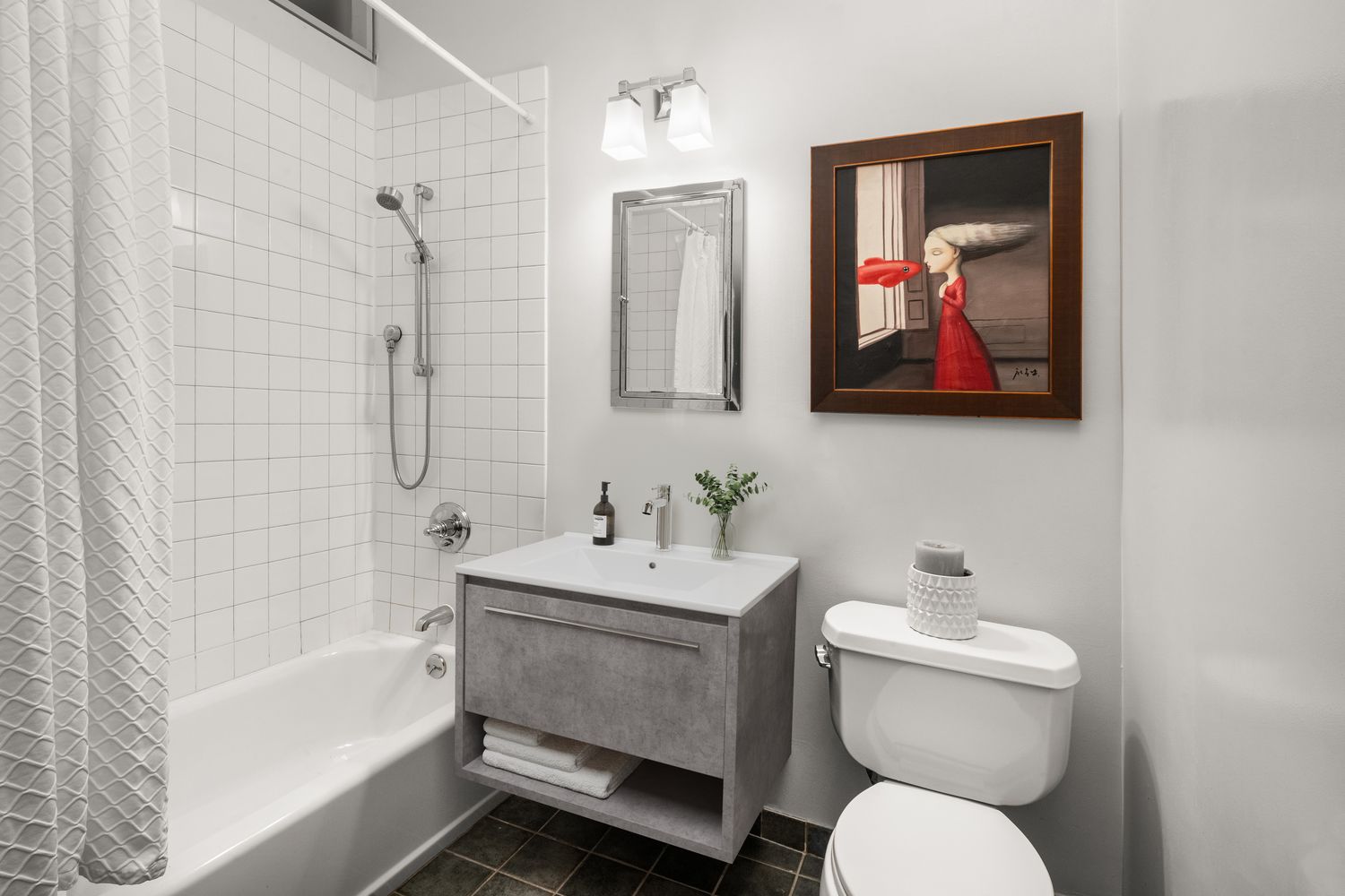 a bathroom with a toilet a sink and bathtub
