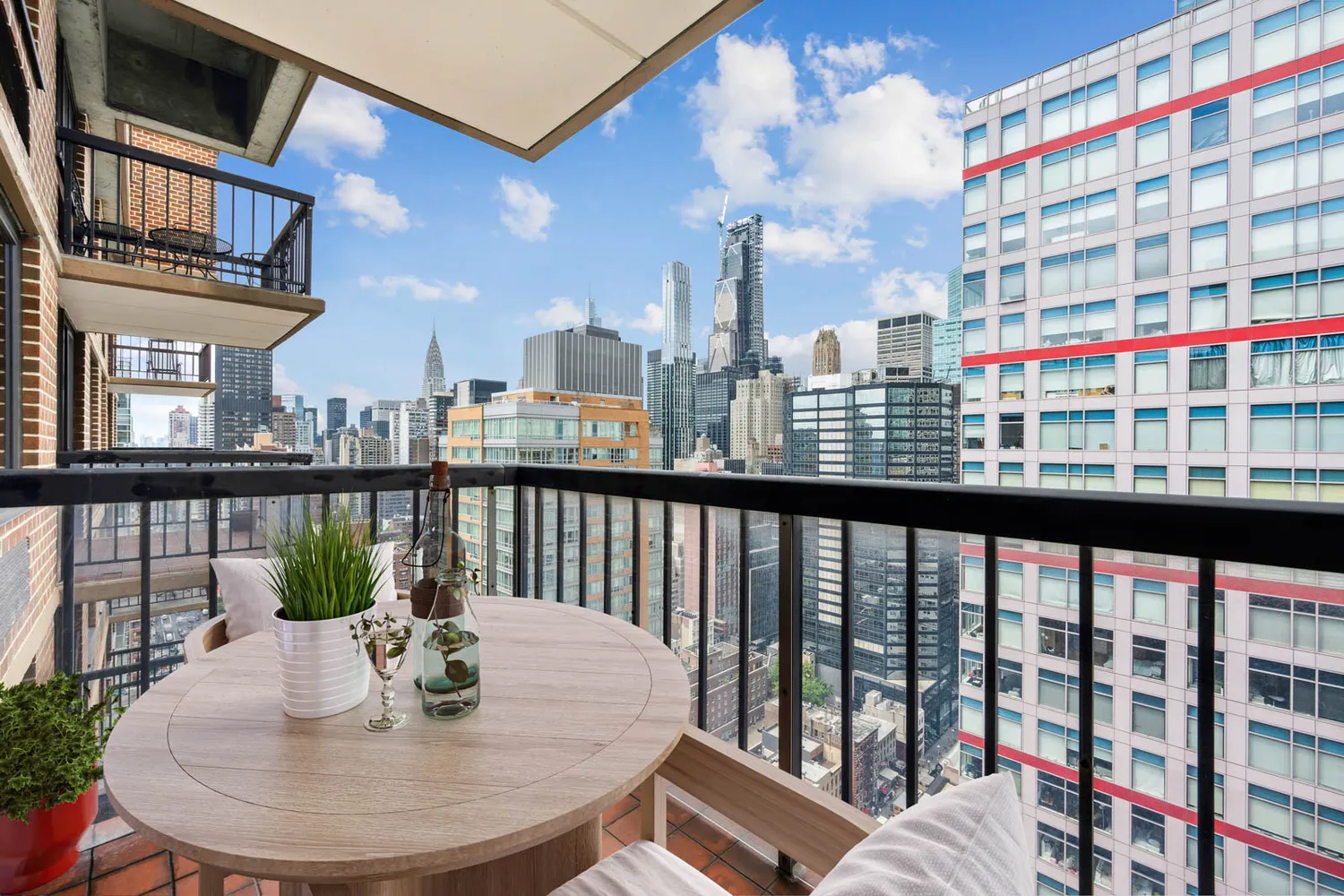 a view of a balcony with dining table and chairs