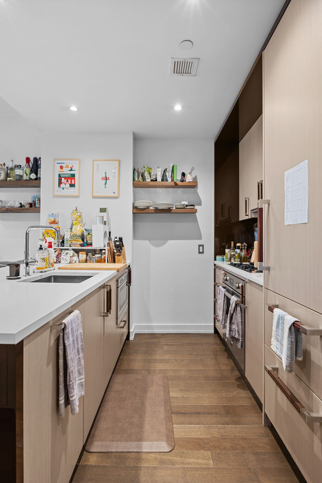 261 West 25th Street, Unit 4A Manhattan, NY 10001 - Photo 5 of 16 a kitchen with white cabinets sink and white appliances