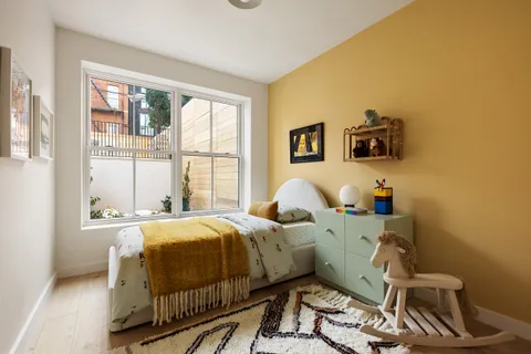 a bed room with two beds and a window