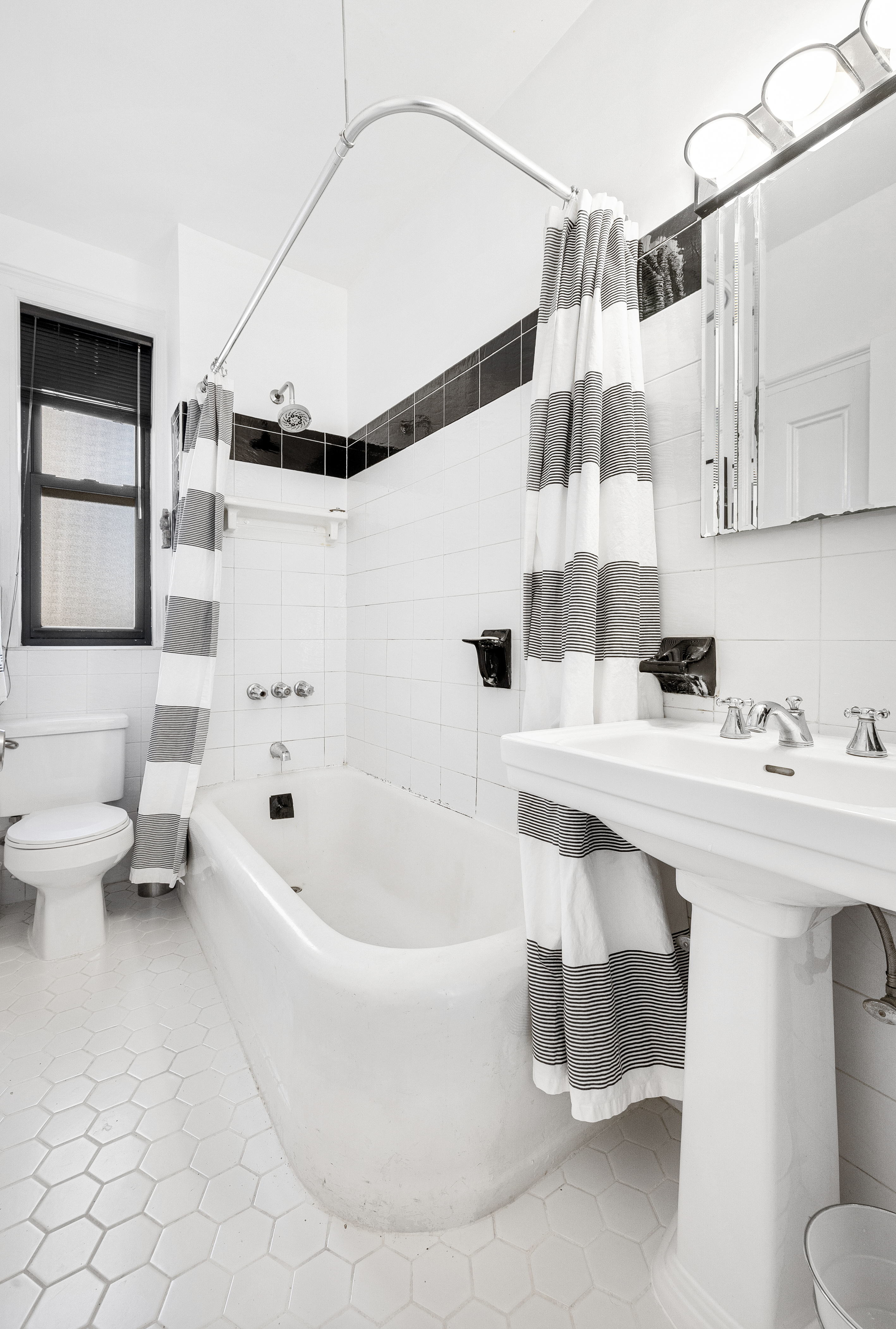 269 West 72nd Street, Unit 9B Manhattan, NY 10023 - Photo 9 of 13 a bathroom with a sink a toilet and bathtub